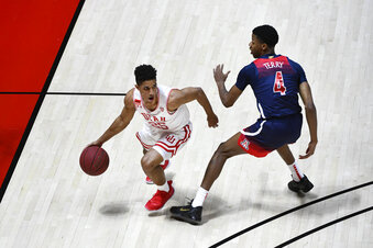 Utah guard Alfonso Plummer (25) drives around Arizona guard Dalen Terry (4) during the first half of an NCAA college basketball game Thursday, Feb. 4, 2021, in Salt Lake City. (AP Photo/Alex Goodlett)