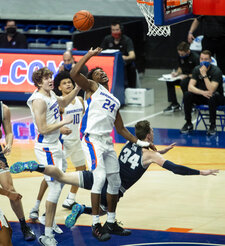 Boise State forward Abu Kigab reaches for a defensive rebound on a drive by Utah State forward Justin Bean during an NCAA college basketball game, Wednesday, Feb. 17, 2021 at ExtraMile Arena in Boise, Idaho. (Darin Oswald/Idaho Statesman via AP)