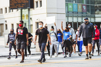 In this Sept. 1, 2020 photo, student-athletes from San Jose State University march from their campus to City Hall to bring awareness to issues of social injustice in San Jose, California. Student-athletes across college campuses are taking a lead from professional athletes by using their platforms in hopes of creating change. (Aubrey Tibbils, San Jose State University Athletics via AP)