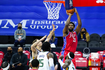 Philadelphia 76ers' Joel Embiid, right, goes up for a shot against Utah Jazz's Bojan Bogdanovic, left, during the first half of an NBA basketball game, Wednesday, March 3, 2021, in Philadelphia. (AP Photo/Matt Slocum)