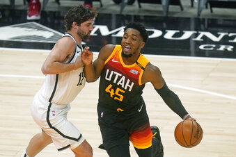 Utah Jazz guard Donovan Mitchell (45) drives around Brooklyn Nets forward Joe Harris (12) in the first half during an NBA basketball game Wednesday, March 24, 2021, in Salt Lake City. (AP Photo/Rick Bowmer)