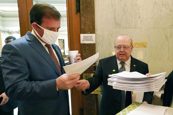 FILE - This March 2, 2021 photo shows Mississippi Senate Finance Committee Chairman Josh Harkins, left,  reviewing a number of proposed bills with Senate Accountability Efficiency and Transparency Committee Chairman John Polk at the Capitol in Jackson, Miss. Responding to concerns from state officials, the U.S. Treasury Department said Wednesday, March 17, 2021 that states can cut taxes without penalty under a new federal pandemic relief law — so long as they use their own funds to do so. (AP Photo/Rogelio V. Solis, file)