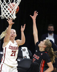 Washington State guard Johanna Teder (21) shoots as Utah forward Zuzanna Puc (5) defends during an NCAA college basketball game in the first round of the Pac-12 women's tournament Wednesday, March 3, 2021, in Las Vegas. (AP Photo/Isaac Brekken)