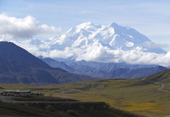 FILE - In this Aug. 26, 2016, file photo sightseeing buses and tourists are seen at a pullout popular for taking in views of North America's tallest peak, Denali, in Denali National Park and Preserve, Alaska. A climber was killed and another was significantly injured when they were hit by a falling block of glacier ice in Alaska's Denali National Park and Preserve, an official said Friday, May 14, 2021. The two were hit by the hanging serac after it dislodged from a peak off the West Fork of the Ruth Glacier. (AP Photo/Becky Bohrer, File)