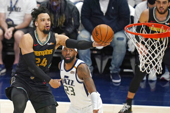 Memphis Grizzlies forward Dillon Brooks (24) lays the ball up as Utah Jazz forward Royce O'Neale (23) looks on during the first half of Game 1 of their NBA basketball first-round playoff series Sunday, May 23, 2021, in Salt Lake City. (AP Photo/Rick Bowmer)