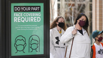FILE - In this March 5, 2021 file photo a sign requiring face masks is seen at City Creek Center in Salt Lake City. Utah will become the latest state to lift its mask mandate on Saturday, April 10, 2021, under a new state law, but the capital city and many businesses will continue requiring masks amid concern about communities still vulnerable to the coronavirus pandemic. (AP Photo/Rick Bowmer,File)
