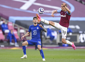 West Ham's Tomas Soucek, right, kicks the ball ahead of Chelsea's Christian Pulisic during the English Premier League soccer match between West Ham United and Chelsea at London Stadium, London, England, Saturday, April 24, 2021. (Justin Setterfield/Pool via AP)