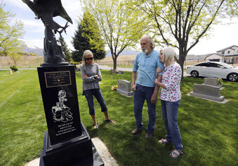 Meghan Burdick, left, and Layne and Kim Olsen visit the grave of their brother and son, Lance Cpl. Nigel Olsen, who was killed in action in Afghanistan, at the Salem City Cemetery in Salem, Utah, Tuesday, May 11, 2021. More than half of Utahns agree that it’s time to end America’s involvement in a war that has cost more than $2 trillion and killed 2,218 U.S. men and women in uniform. To date, 53 Utahns have lost their lives in Afghanistan and Iraq.(Kristin Murphy/The Deseret News via AP)