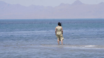 Amelia Gotbetter stands at the Great Salt Lake Tuesday, June 15, 2021, near Salt Lake City. Salt Lake City set another heat record Tuesday, June 15, 2021, and experienced its hottest day of the year as the state's record-breaking heat wave persists. Utah's capitol hit 104 degrees, breaking the previous heat record for that date of 103 degrees, according to information from the National Weather Service. On Monday, Salt Lake City hit 103 degrees to break a heat record for that date set nearly 50 years ago. (AP Photo/Rick Bowmer)