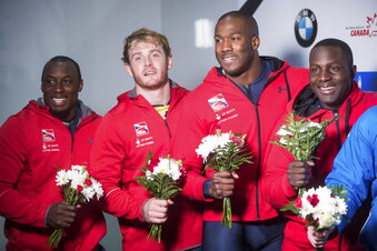 FILE - Great Britain's Andrew Matthews, from left to right, Ben Simons, Toby Olubi and Lamin Deen celebrate after their second-place finish in a four-man World Cup Bobsleigh race in Whistler, British Columbia, in this Saturday, Nov. 25, 2017, file photo. British Bobsleigh and Skeleton announced Thursday, June 17, 2021, that the four-man team of Deen, Simons, Olubi and Matthews has been upgraded to the gold medal for a race that occurred Nov. 25, 2017 in Whistler, Canada. The Russian crew that beat them that day has since been disqualified. (Darryl Dyck/The Canadian Press via AP, File)