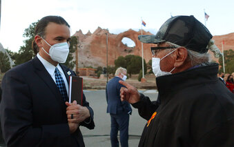 FILE - In this April 22, 2021, file photo, Bryan Newland, left, speaks with Navajo Nation Council Delegate Daniel Tso in Window Rock, Ariz. President Joe Biden's nominee to oversee Indigenous affairs at the Interior Department said Wednesday, June 9, 2021, that he won't impede tribes as they seek to improve infrastructure, public safety and the economy on their lands. Newland appeared before the Senate Indian Affairs Committee where he received widespread support to become assistant secretary for Indian Affairs. (AP Photo/Felicia Fonseca, File)