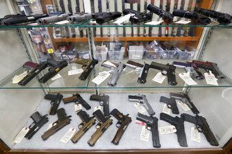 FILE - In this March 25, 2020, file photo semi-automatic handguns are displayed at shop in New Castle, Pa. The number of people stopped from buying guns though the U.S. background check system hit an all-time high of more than 300,000 last year amid a surge of firearm sales, according to new records obtained by the group Everytown for Gun Safety.  The FBI numbers provided to The Associated Press show the background checks blocked nearly twice as many gun sales in 2020 as in the year before.  (AP Photo/Keith Srakocic, File)