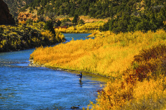 FILE - In this Oct. 14, 2020, file photo, a fisherman tries his luck in the Colorado River near Burns, Colo. Colorado officials lifted some fishing restrictions along a 27-mile (43-kilometer) stretch of the Colorado RIver, Tuesday, July 20, 2021, thanks to recent rains and lower water temperatures essential to fish. (Chris Dillmann/Vail Daily via AP)