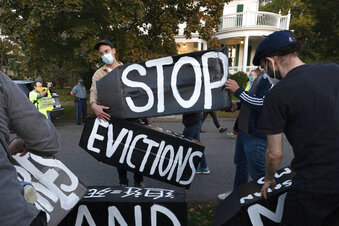 FILE - In this Oct. 14, 2020, file photo, housing activists erect a sign in Swampscott, Mass. The Biden administration announced Thursday, July 29, 2021, it will allow a nationwide ban on evictions to expire Saturday, arguing that its hands are tied after the Supreme Court signaled it would only be extended until the end of the month. The White House said President Joe Biden would have liked to extend the federal eviction moratorium due to spread of the highly contagious delta variant. Instead, Biden called on "Congress to extend the eviction moratorium to protect such vulnerable renters and their families without delay." (AP Photo/Michael Dwyer, File)