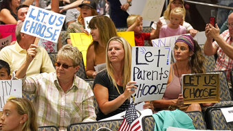 People listen to the Salt Lake County Council before their vote to overturned the health department's "order of restraint" on Thursday, Aug. 12, 2021, that would have required K-6 students to wear masks when school starts next week. (AP Photo/Rick Bowmer)