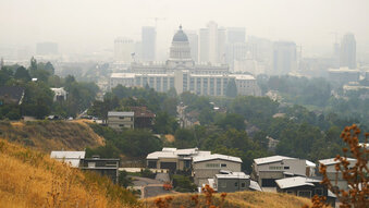 Smoke shrouds the Utah State Capitol and downtown skyline Friday, Aug. 6, 2021, in Salt Lake City. Smoke from wildfires out west have created hazy conditions throughout the region. (AP Photo/Rick Bowmer)