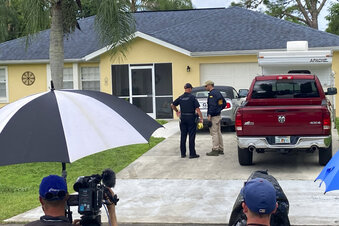 Law enforcement officials investigate home of a young man wanted for questioning in the disappearance of his girlfriend, Gabby Petito, on Monday, Sept. 20, 2021 in North Port, Fla.  The officers served a search warrant at the home of the parents of her 23-year-old boyfriend Brian Laundrie, who is wanted for questioning. (AP Photo/Curt Anderson)