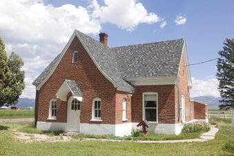 A single building stands on the grounds that once contained an Indigenous boarding school Thursday, Aug. 26, 2021, in Panguitch, Utah. Utah is just starting to reconcile its own history of Indian residential schools with the proposed excavation on the site of a former school in Panguitch that is believed to have over a dozen bodies of Native American children. (Chris Caldwell/The Spectrum via AP)