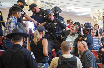 FILE - Far-right activist Ammon Bundy is dragged from the Idaho Senate Chambers gallery by Idaho State Troopers after returning to the Idaho Statehouse in Boise, Idaho, Aug. 26, 2020. Bundy, who's running for governor in Idaho, has been arrested again after refusing to leave a hospital in connection with a child-welfare case, police said Saturday, March 12, 2022.  (Darin Oswald//Idaho Statesman via AP, File)