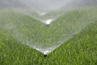 A sprinkler waters grass in Sandy, Utah, Tuesday, May 31, 2022. A Brigham Young University study says Utahns harm lawns with too much water. (Chuck Wing/The Deseret News via AP)