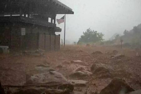 Arizona levee breached, hiker missing after floods hit West