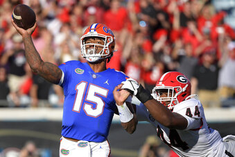 FILE - Florida quarterback Anthony Richardson (15) throws a pass while under pressure from Georgia defensive lineman Travon Walker during the first half of an NCAA college football game Oct. 30, 2021, in Jacksonville, Fla. Richardson is now Florida’s unchallenged – and still unproven — starting quarterback, a budding star who’s already become a popular name found near the top of several 2023 NFL mock drafts. But he needs to stay heathy, something he failed to do as a backup last season. (AP Photo/Phelan M. Ebenhack, File)