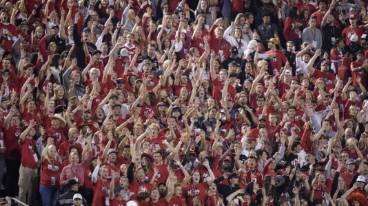 The Utah student section show their support during the first half of an NCAA college football game against San Diego State and Utah Saturday, Sept. 17, 2022, in Salt Lake City. A University of Utah student was arrested on suspicion of making terrorist threats after police said she threatened to detonate a nuclear reactor if the school's football team failed to win a game last Saturday. Charging documents filed in Salt Lake City on Wednesday, Sept. 21, 2022 allege that the student posted threats before Utah's game against San Diego State University on Saturday. (AP Photo/Rick Bowmer)