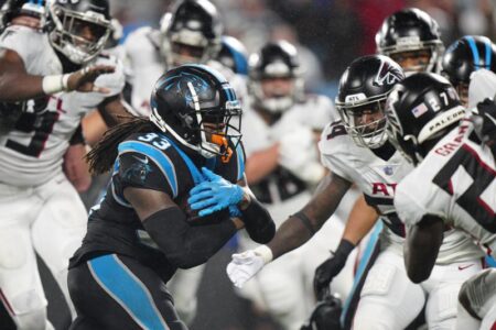 Foreman leads Panthers past rival Falcons in rain, 25-15