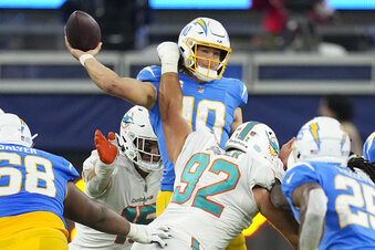 Los Angeles Chargers quarterback Justin Herbert, top, throws under pressure from Miami Dolphins defensive tackle Zach Sieler (92) during the second half of an NFL football game Sunday, Dec. 11, 2022, in Inglewood, Calif. (AP Photo/Mark J. Terrill)