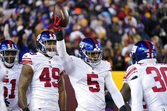 New York Giants defensive end Kayvon Thibodeaux (5) celebrates after scoring a touchdown during the first half of an NFL football game against the Washington Commanders, Sunday, Dec. 18, 2022, in Landover, Md. (AP Photo/Susan Walsh)