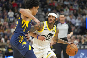 Indiana Pacers guard Andrew Nembhard, left, guards against Utah Jazz guard Jordan Clarkson (00) during the second half of an NBA basketball game Friday, Dec. 2, 2022, in Salt Lake City. (AP Photo/Rick Bowmer)