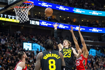 Utah Jazz forward Lauri Markkanen (23) lays the ball up while contested by New Orleans Pelicans guard Trey Murphy III (25) in the first half during an NBA basketball game Tuesday, Dec. 13, 2022, in Salt Lake City. (AP Photo/Isaac Hale)