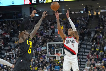 Portland Trail Blazers guard Anfernee Simons (1) shoots as Utah Jazz forward Jarred Vanderbilt (8) defends during the first half of an NBA basketball game Saturday, Dec. 3, 2022, in Salt Lake City. (AP Photo/Rick Bowmer)