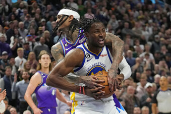 Utah Jazz guard Jordan Clarkson, rear, fouls Golden State Warriors forward Jonathan Kuminga during the second half of an NBA basketball game Wednesday, Dec. 7, 2022, in Salt Lake City. (AP Photo/Rick Bowmer)