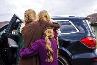 FILE - Three girls embrace before they are removed from the home of Samuel Bateman, following his arrest in Colorado City, Ariz., on Wednesday, Sept. 14, 2022.  Federal documents released Friday, Dec. 2 show that Bateman, the leader of a small polygamous group near the Arizona-Utah border, had taken at least 20 wives, most of whom were minors, and punished followers who did not treat him as a prophet.  (Trent Nelson/The Salt Lake Tribune via AP, File)