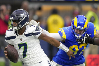 Los Angeles Rams defensive tackle Michael Hoecht (97) sacks Seattle Seahawks quarterback Geno Smith (7) during the first half of an NFL football game Sunday, Dec. 4, 2022, in Inglewood, Calif. (AP Photo/Mark J. Terrill)