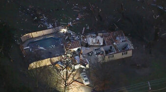 A structure is damaged after a tornado touched down in Wayne, Okla., early Tuesday, Dec. 13, 2022. Millions of people in the central United States from the Rocky Mountains to the Midwest are bracing for blizzard-like conditions from a massive storm blowing across the country. States farther to the south, including Texas and Oklahoma, saw tornadoes early Tuesday, with some damage reported in Oklahoma.  (KOCO via AP)