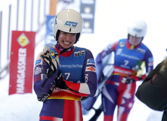 Chevonne Chelsea Forgan and Sophia Kirkby of United States smile after they placed second after their second run of the Luge World Cup women's doubles race in Sigulda, Latvia, Saturday, Jan. 7, 2023. (AP Photo/Roman Koksarov)