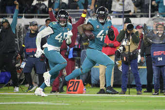 Jacksonville Jaguars linebacker Josh Allen (41) returns a fumble for a touchdown as defensive end Arden Key (49) covers in the second half of an NFL football game against the Tennessee Titans, Saturday, Jan. 7, 2023, in Jacksonville, Fla. (AP Photo/Phelan M. Ebenhack)