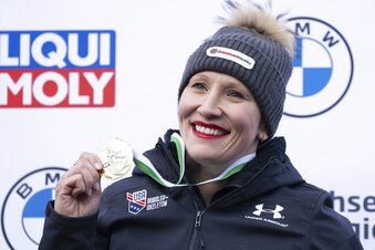 First placed Kaillie Humphries from the USA stands on the podium during the award ceremony  for the women's monobob Bobsleigh World Cup race in Altenberg, Germany, Saturday, Jan. 14, 2023. (Sebastian Kahnert/dpa via AP)