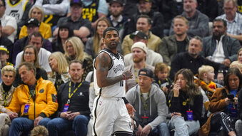 Brooklyn Nets guard Kyrie Irving (11) looks on during the first half of an NBA basketball game against the Utah Jazz, Friday, Jan. 20, 2023, in Salt Lake City. (AP Photo/Rick Bowmer)