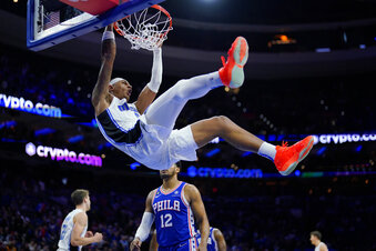 Orlando Magic's Paolo Banchero, top, dunks during the second half of an NBA basketball game against the Philadelphia 76ers, Monday, Jan. 30, 2023, in Philadelphia. (AP Photo/Matt Slocum)