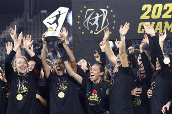 FILE - Portland Thorns FC players celebrates with the trophy after winning the NWSL championship soccer match against the Kansas City Current, on Oct. 29, 2022, in Washington. The National Women's Soccer League is close to expanding by three teams, which will be in Boston, Utah and the San Francisco area, according to a Friday, Jan. 27, 2023,  report in the Wall Street Journal.  (AP Photo/Nick Wass, File)