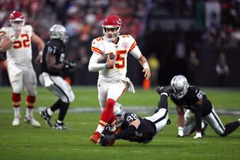 Kansas City Chiefs quarterback Patrick Mahomes runs with the ball against the Las Vegas Raiders during the first half of an NFL football game Saturday, Jan. 7, 2023, in Las Vegas. (AP Photo/John Locher)