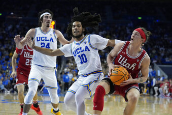 Utah guard Gabe Madsen, right, is defended by UCLA guard Tyger Campbell (10) during the first half of an NCAA college basketball game Thursday, Jan. 12, 2023, in Los Angeles. (AP Photo/Marcio Jose Sanchez)