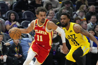 Atlanta Hawks guard Trae Young (11) drives as Utah Jazz guard Mike Conley (11) defends during the first half of an NBA basketball game Friday, Feb. 3, 2023, in Salt Lake City. (AP Photo/Rick Bowmer)