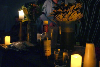 A pitcher of ayahuasca, right, sits on an altar covered by a bundle of leaves called a “wayra” used in a spiritual ceremony hosted by Hummingbird Church in Hildale, Utah, on Saturday, Oct. 15, 2022. Ayahuasca is a psychoactive brew containing an Amazon shrub that is known to cause visions lasting several hours. A rising demand for the plant medicine has spurred the formation of hundreds of groups like Hummingbird across the U.S. (AP Photo/Jessie Wardarski)