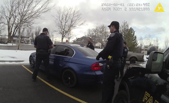 In this image taken from from police body-worn camera video provided by the Farmington City, Utah, Police Department, police officers surround a vehicle a traffic stop, Wednesday, March 1, 2023, in Farmington, Utah. The footage released by the suburban police department in Utah on Wednesday, Mach 8, 2023, shows five officers opening rounds of fire into all sides of a car after they can be heard alerting each other that the driver, 25-year-old Chase Allan, has a gun. The Allan family has since raised questions about police actions.  (Farmington City Police Department via, AP)