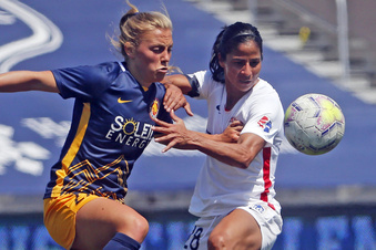 FILE -  Utah Royals FC defender Madeline Nolf, left, battles with OL Reign midfielder Shirley Cruz, right, during the first half of an NWSL Challenge Cup soccer match at Zions Bank Stadium, Wednesday, July 8, 2020, in Herriman, Utah. The Royals are returning to Utah and the National Women's Soccer League. The NWSL and Major League Soccer's Real Salt Lake announced the second iteration of the Utah Royals on Saturday, March 11, 2023.. The Royals were part of the NWSL for three seasons from 2018 to 2020. (AP Photo/Rick Bowmer, File)