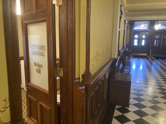 The entrance to the Wyoming Attorney General's office in the Wyoming State Capitol in Cheyenne, Wyo., is shown Tuesday, March 14, 2023. Wyoming Attorney General Bridget Hill has not released any of her advisory opinions for state and local government officials since she took office in 2019, saying all are shielded by attorney-client privilege. Such documents are posted online dozens of times a year in states including California and Texas but they're difficult to impossible to find in several other states, an Associated Press review has found. (AP Photo/Mead Gruver)
